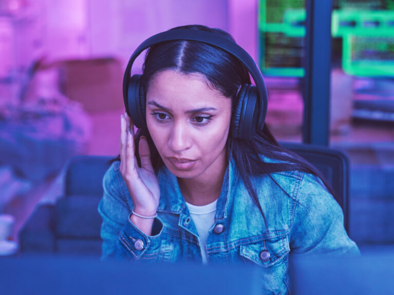 Developer, computer or headphones in neon coding for cybersecurity iot, night SEO thinking or code .